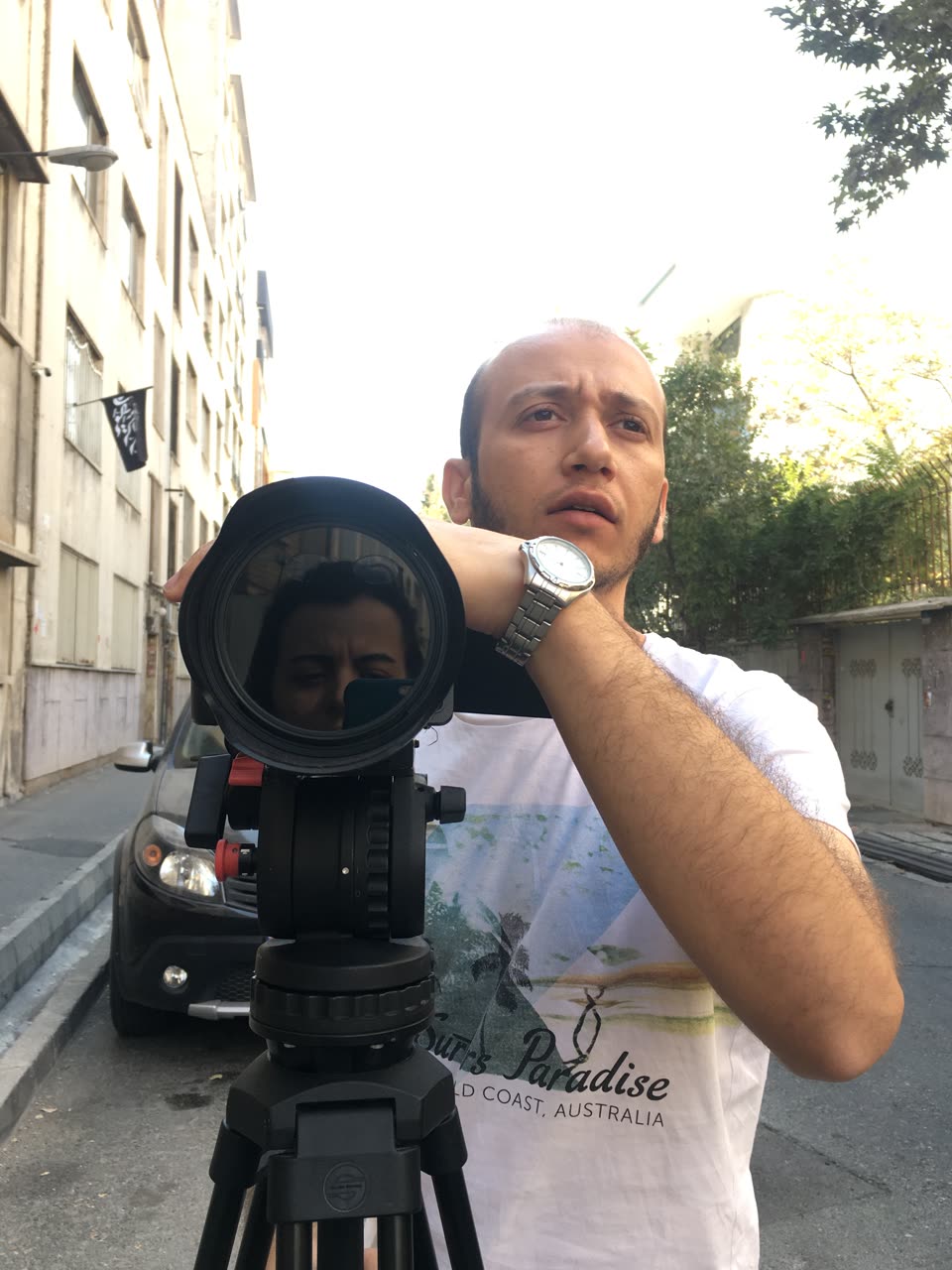 On set: the camera on a tripod in a sunny street